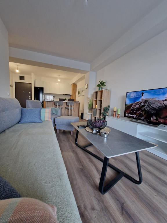 a living room with a couch and a table at Apartment Dalas 2 Star Dojran in Star Dojran