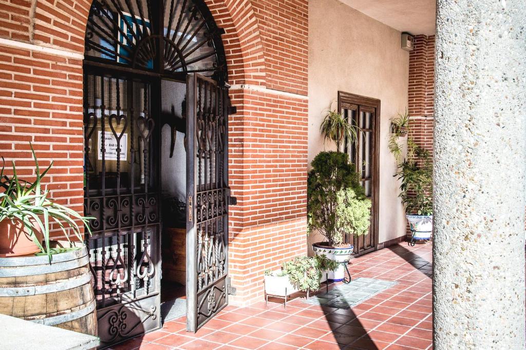 an entrance to a brick building with an iron gate at Hostal Goya II in Carbonero el Mayor