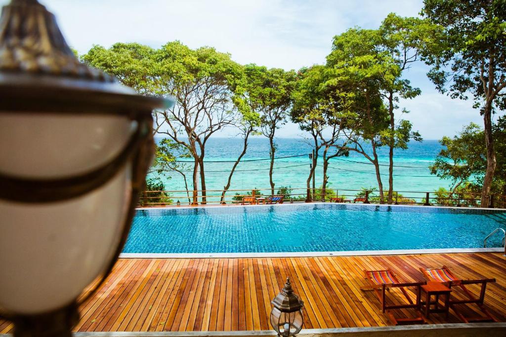 a swimming pool with a view of the ocean at Phi Phi Phu Chalet Resort in Phi Phi Islands