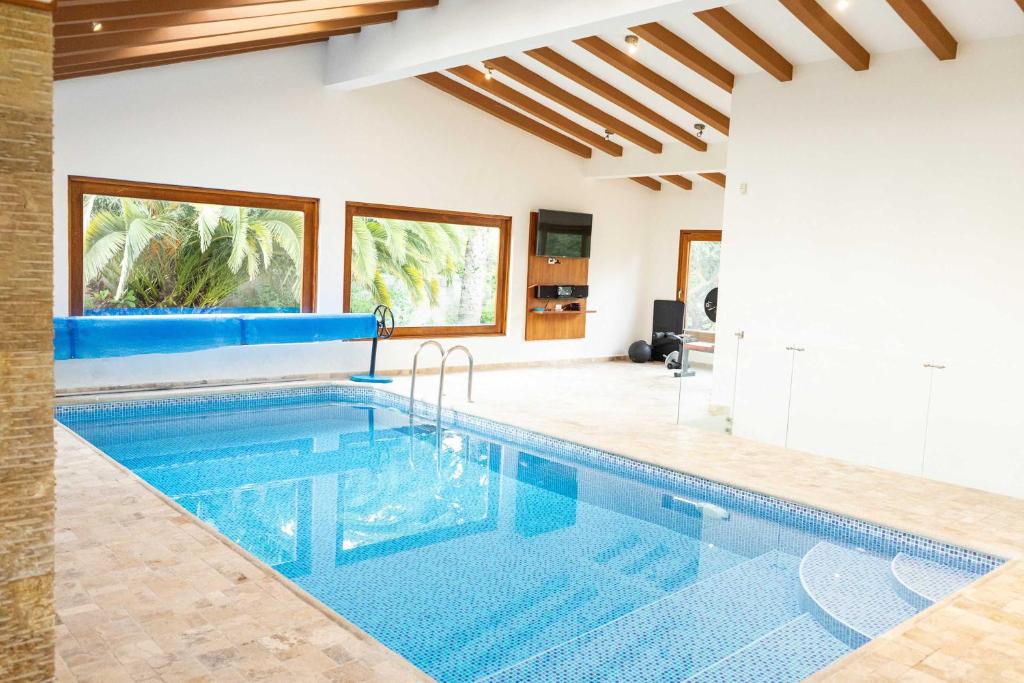 a swimming pool in a house at BUHO Luxury Guayllabamba Home BBQ Jacuzzi Pool in Quito