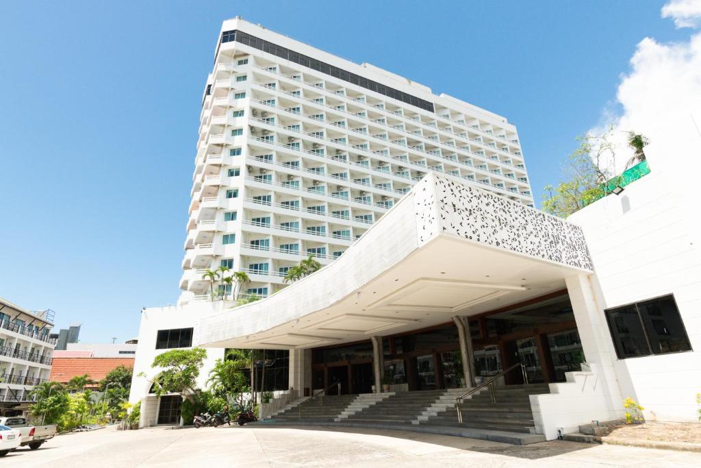 a large white building with stairs in front of it at Royal Twins Palace Hotel in Pattaya
