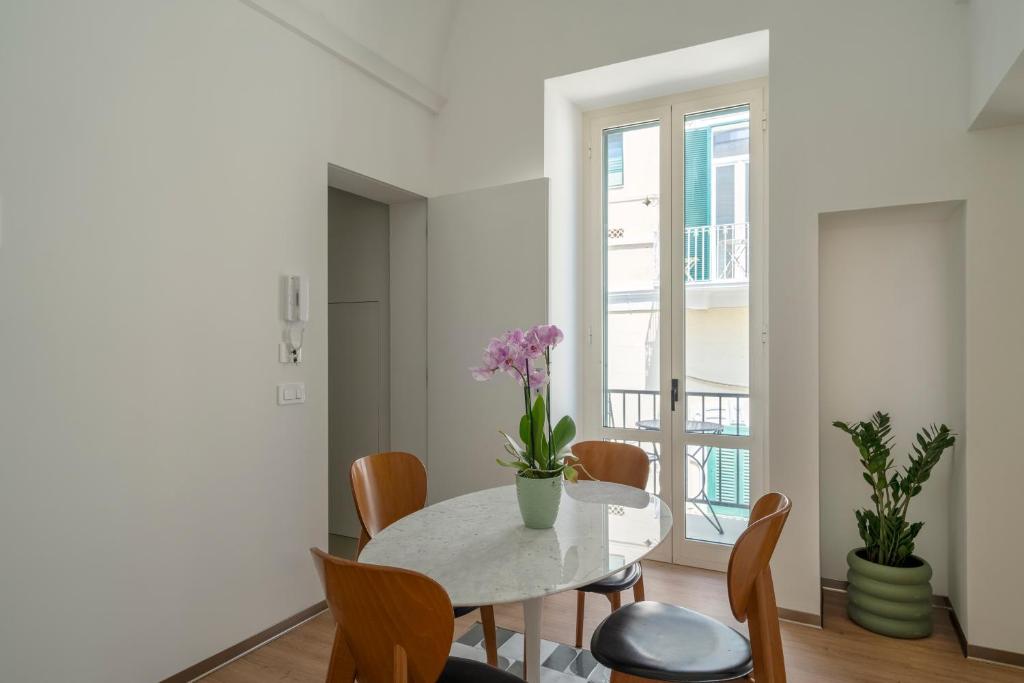 a white dining room with a table and chairs at Design Apartment in Monopoli