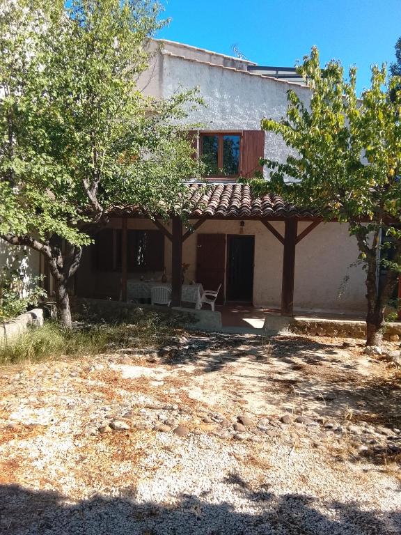 a house with trees in front of it at La Bastide Rempelin in Aix-en-Provence