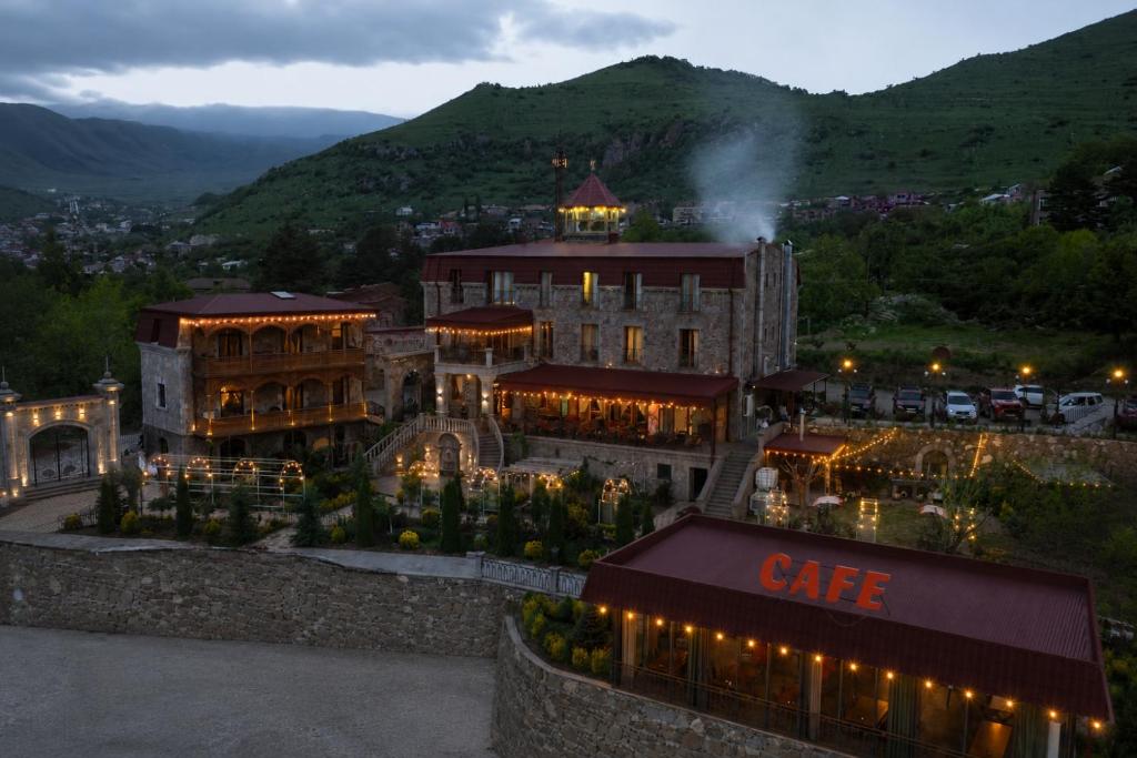 a large building with a cafe sign in front of it at Khoreayi Dzor in Goris