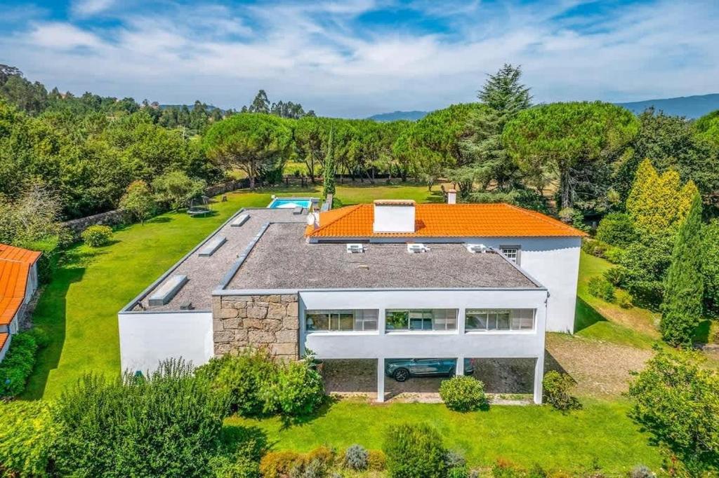 an overhead view of a house with an orange roof at Portugal Active Oliveiras Farm in Viana do Castelo