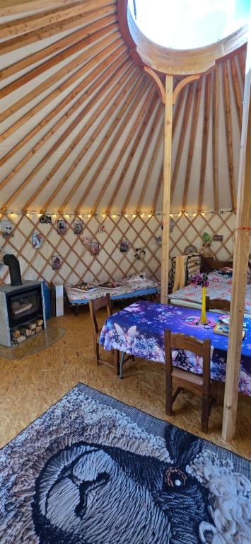 a room with a bed and a rug in a yurt at 01 JURTA šedá u stodoly in Chotětice