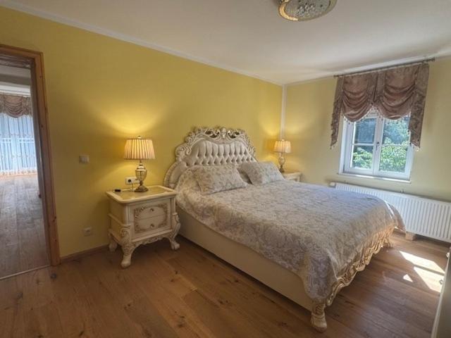 a bedroom with a bed and a night stand with two lamps at Zum Böhmen Ferienwohnung Fridericke in Bad Langensalza
