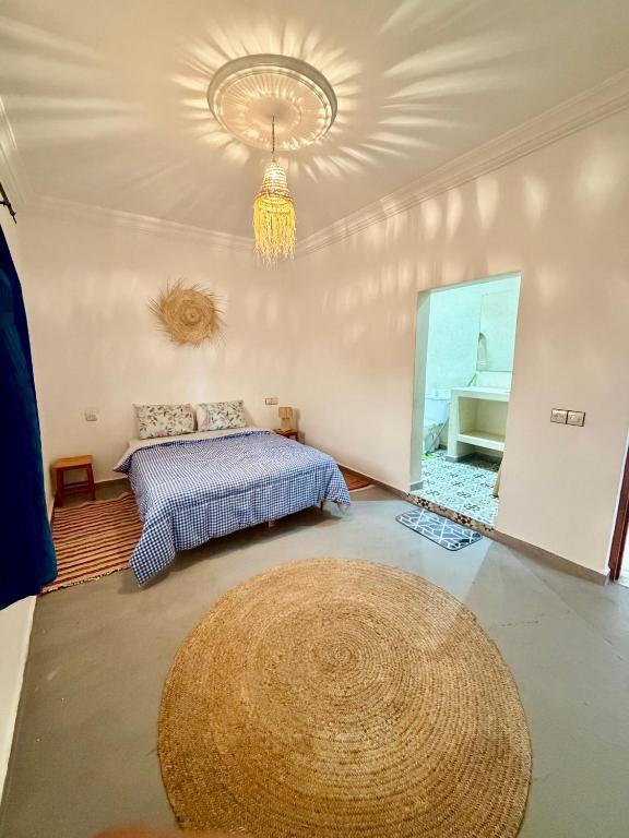 a bedroom with a bed and a large rug at Dar Rime in Ghazoua