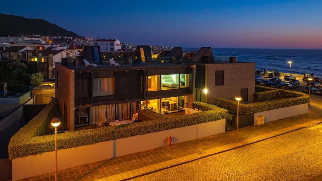 a building with a view of the ocean at night at Moledo Front Beach by Portugal Active in Viana do Castelo