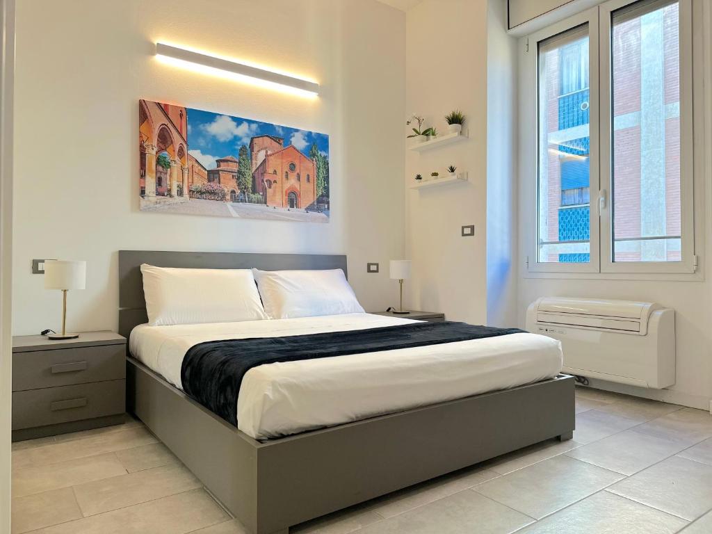 a bedroom with a bed and a painting on the wall at Demetra Apartment in Bologna