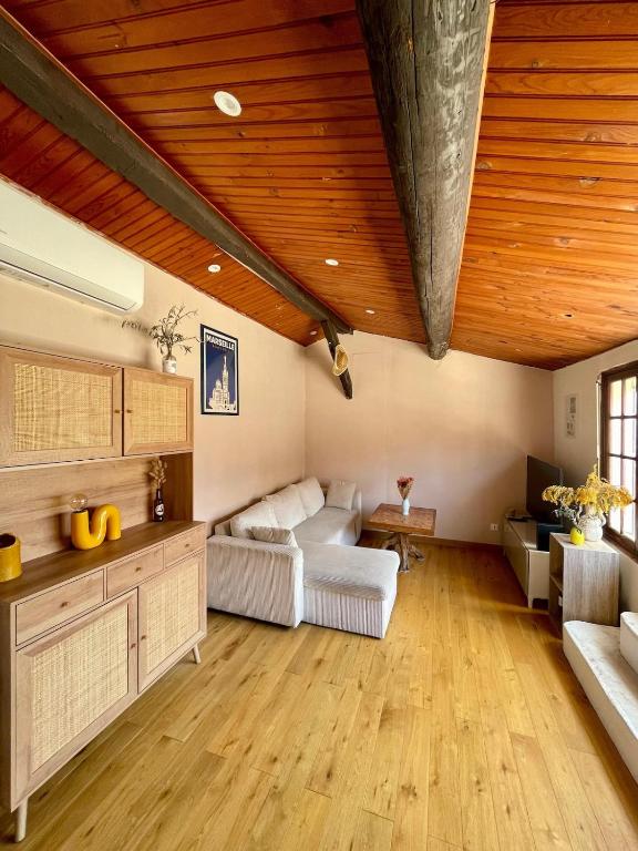 a living room with a wooden ceiling and a couch at Downtown apartment in Marseille