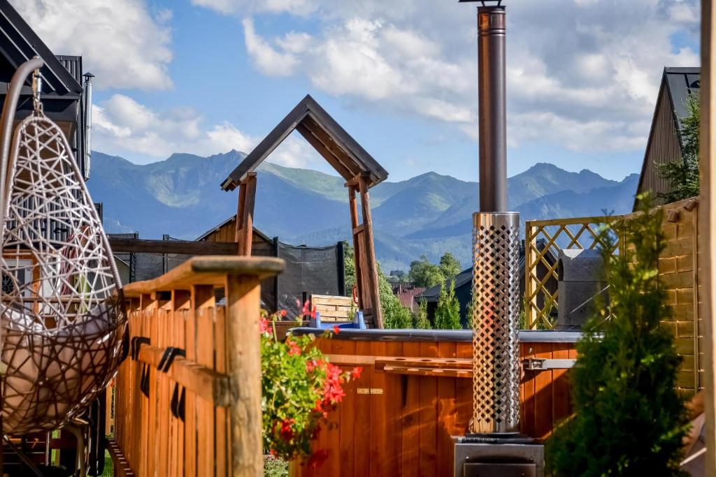 a deck with a view of mountains in the background at Domek u Hanci Pod Gubałówką z Jacuzzi in Ząb