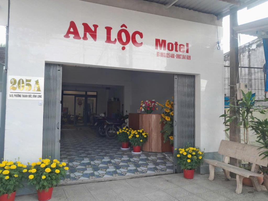an ico motel with flowers in front of it at An Loc Motel in Vĩnh Long