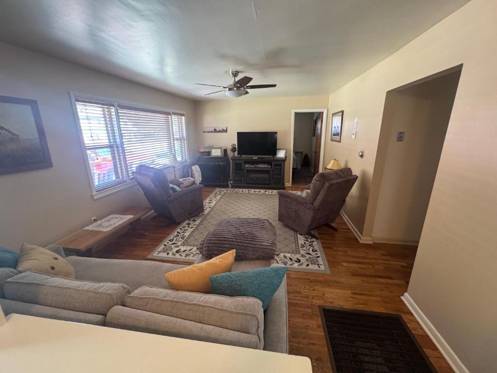 a living room with a couch and a tv at Dash House in Deadwood