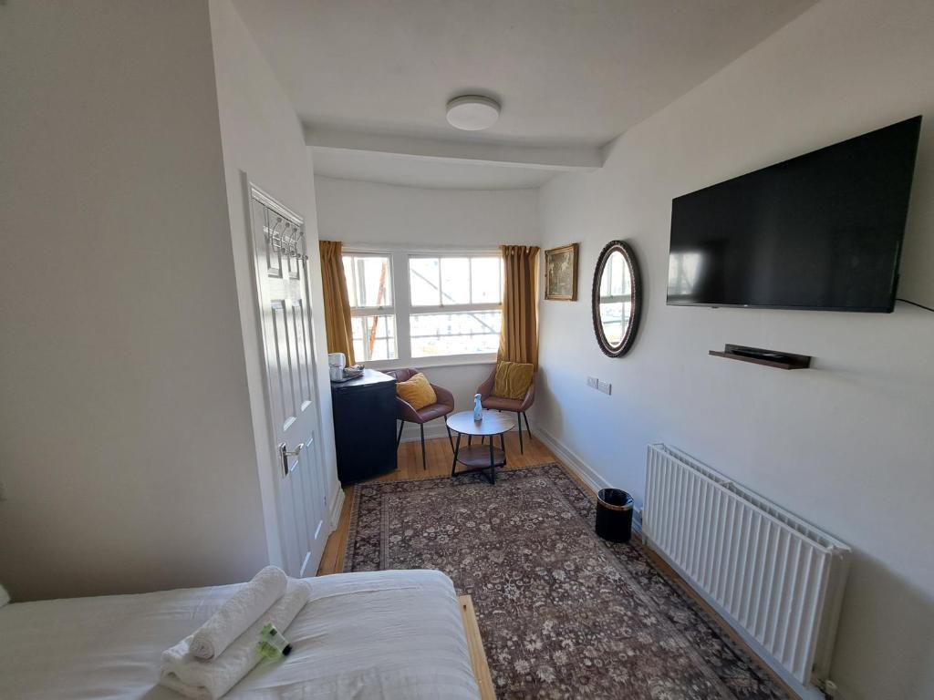 a bedroom with a bed and a flat screen tv at The West Pier Residence in Brighton & Hove