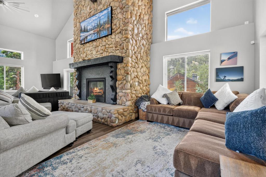 a living room with a large stone fireplace at Manor at Brighton in Brighton