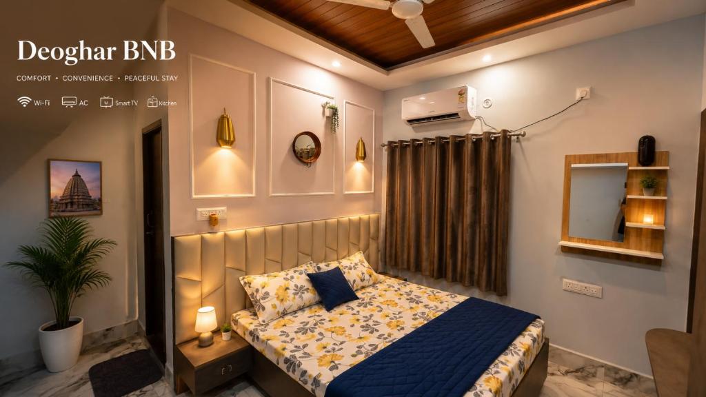a bedroom with a bed with a blue comforter at Deoghar BnB in Deoghar