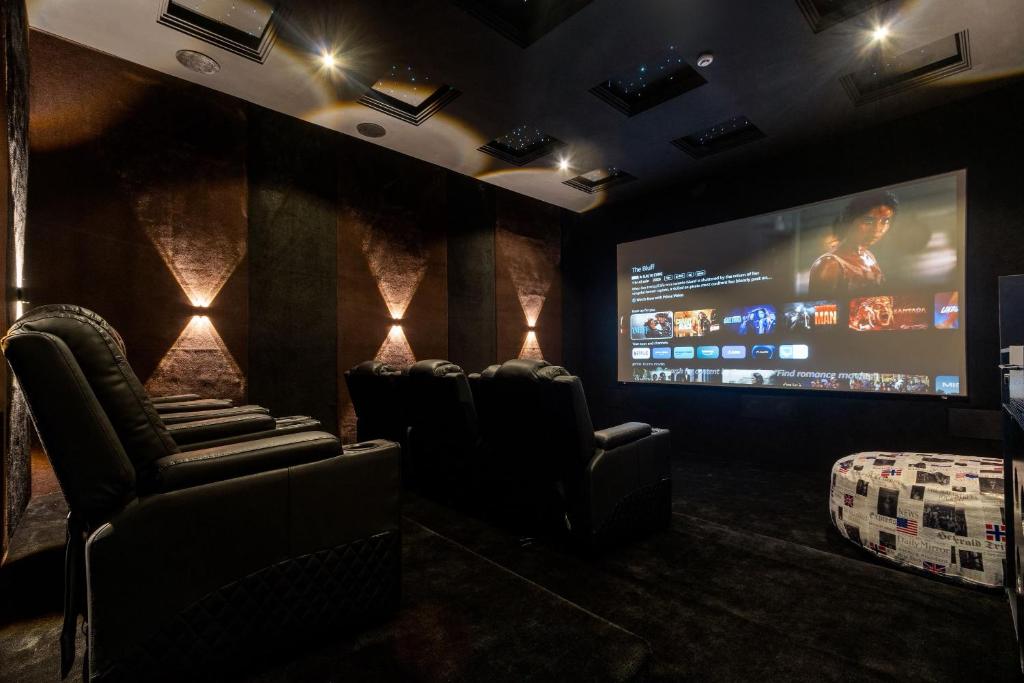 a cinema room with chairs and a large screen at Yaniv Apartments Oniru in Lagos