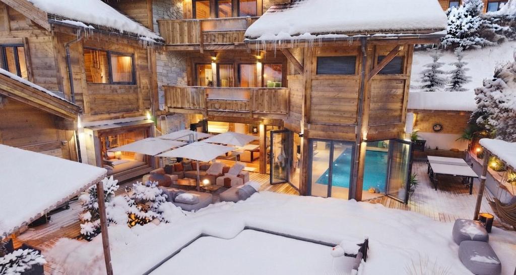 a house in the snow with a pool at Chalet ORPIN Serre-Chevalier piscine cinéma sauna in Le Monêtier-les-Bains