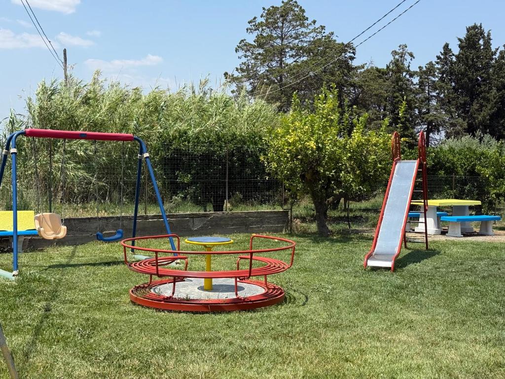 a playground with a picnic table and a slide at Agriturismo Bufaleria in Scanzano