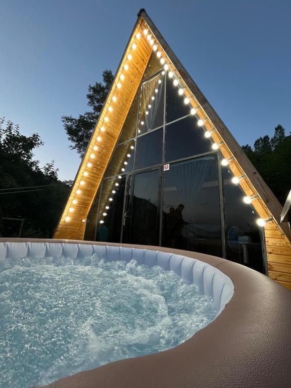 a hot tub with lights in front of a building at Green Garden in Alayaz