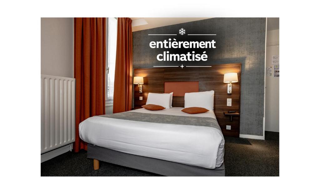 a hotel room with a bed and a sign that reads entitlement climate at Hotel Continental in Angers