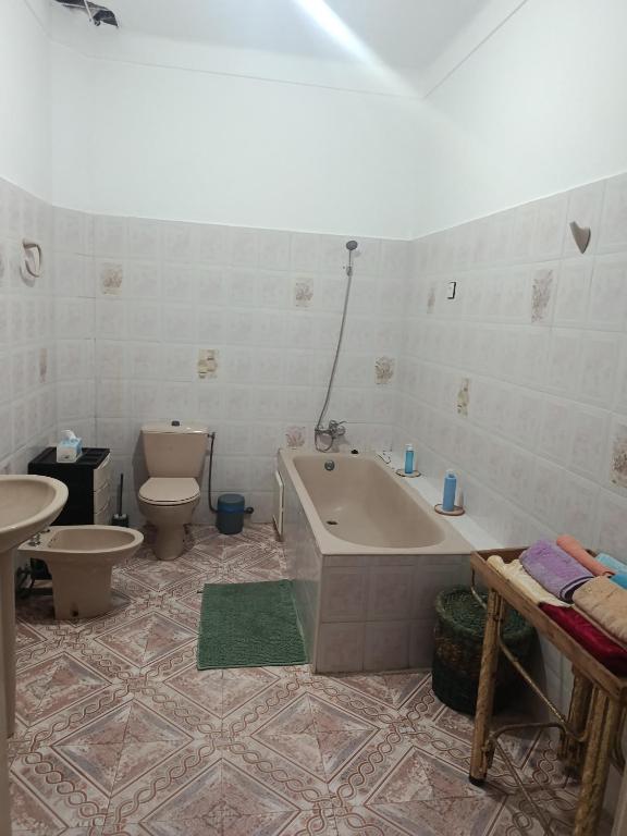 a bathroom with a tub and a toilet and a sink at Dar Cadi in Safi