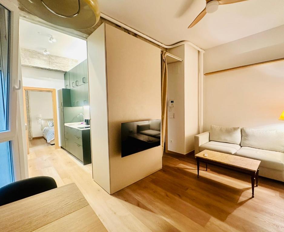 a living room with a couch and a table at Central Bilbao, 3min walk to Guggenheim with AC in Bilbao