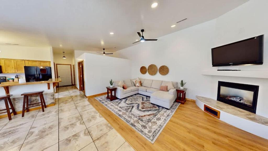 a living room with a couch and a flat screen tv at Canyon Portal #469 in Moab