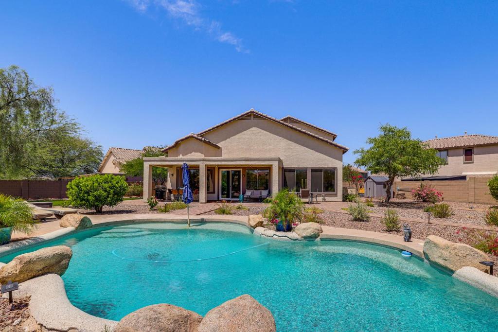 a house with a swimming pool in front of a house at Fire Pit & Large Yard! Luxury Anthem Escape in Anthem