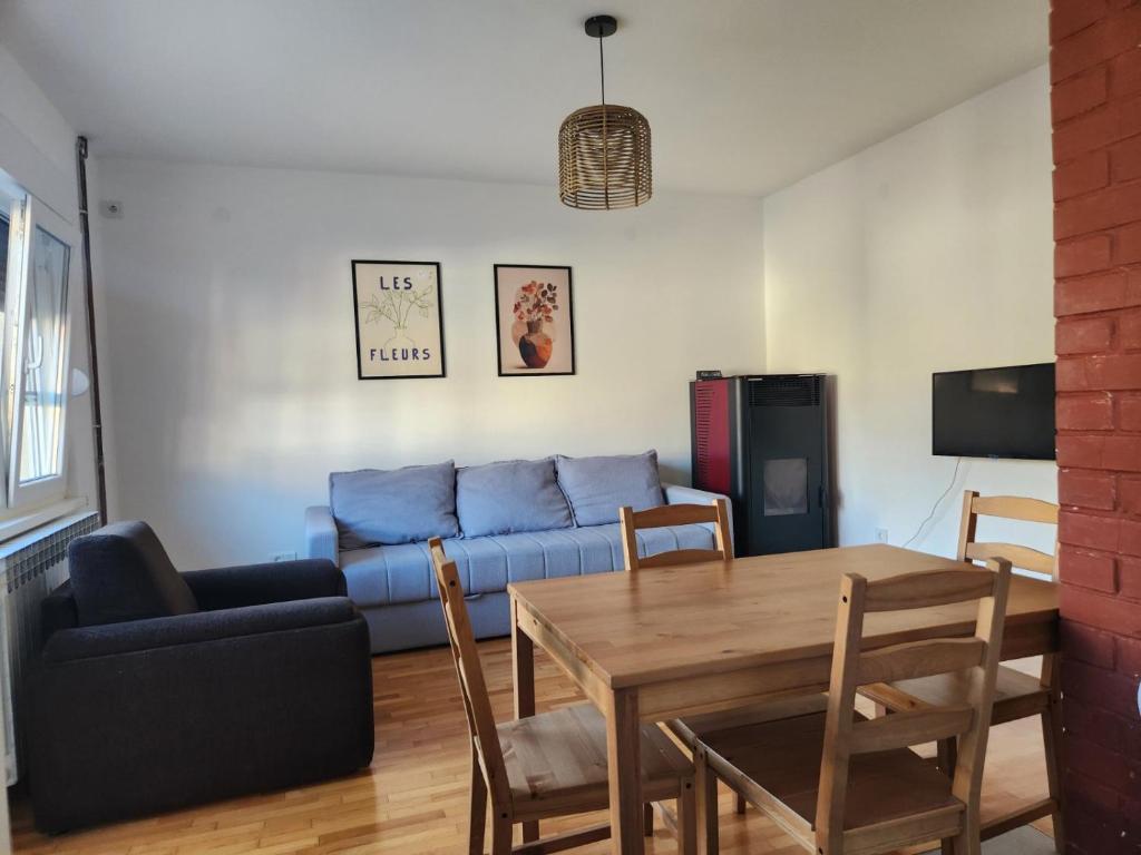 a living room with a blue couch and a table at Drinika in Foča