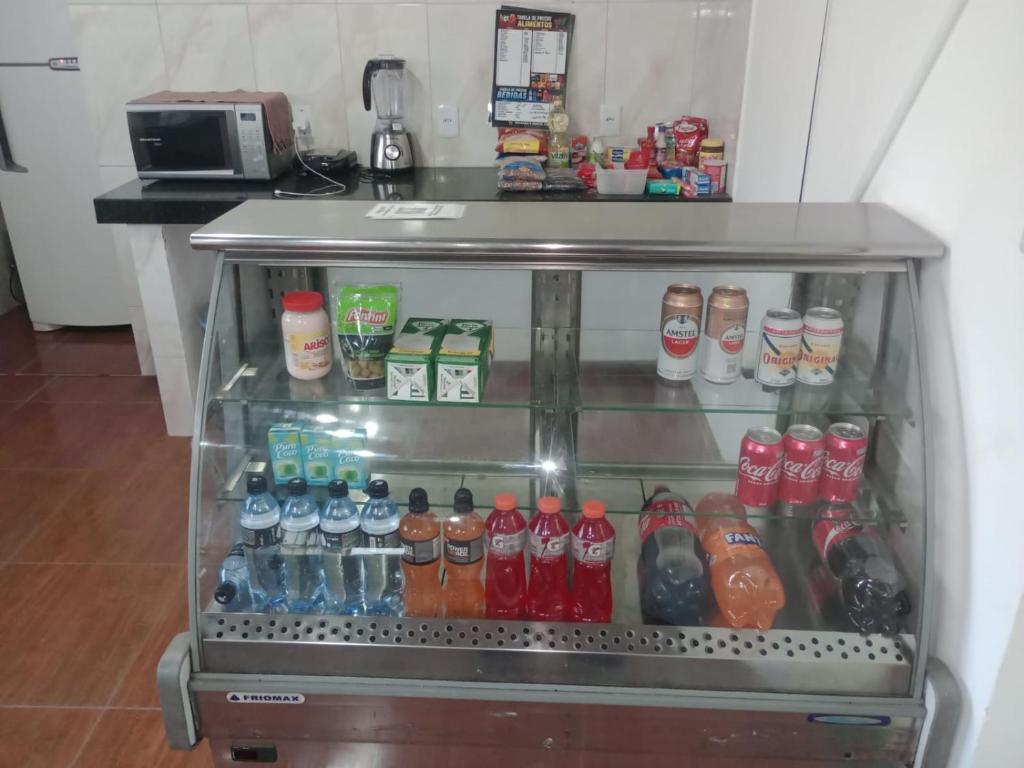 a refrigerator filled with lots of different types of drinks at Pousada e Hostel Campo in Vespasiano
