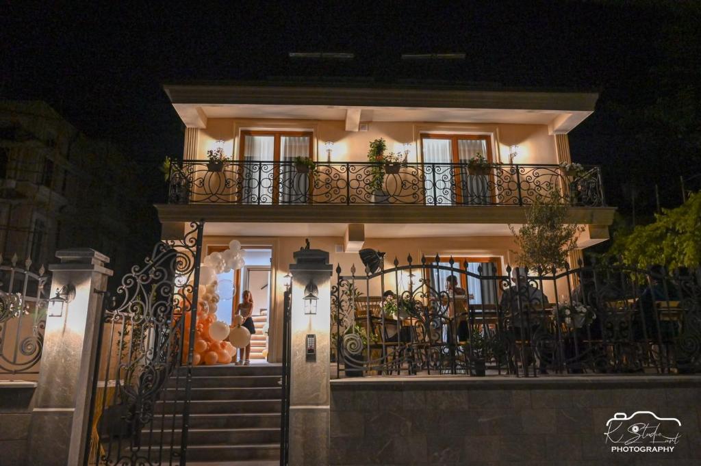a house with a staircase leading to the front door at night at Rubin Boutique in Korçë