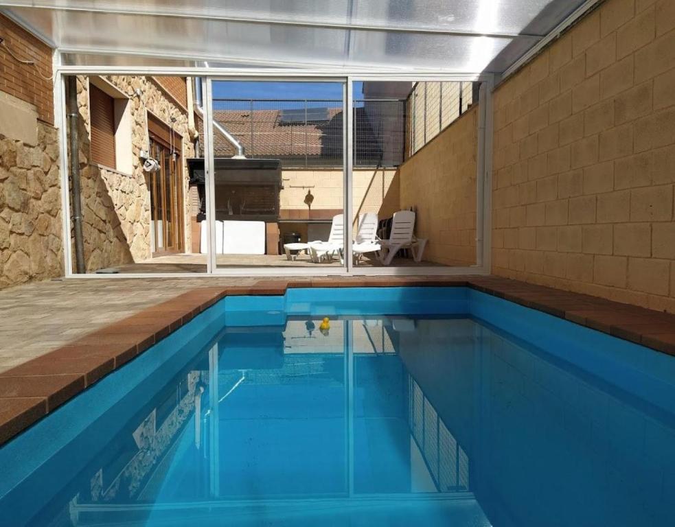 a swimming pool with blue water in a house at La Casona De Cuellar in Cuéllar