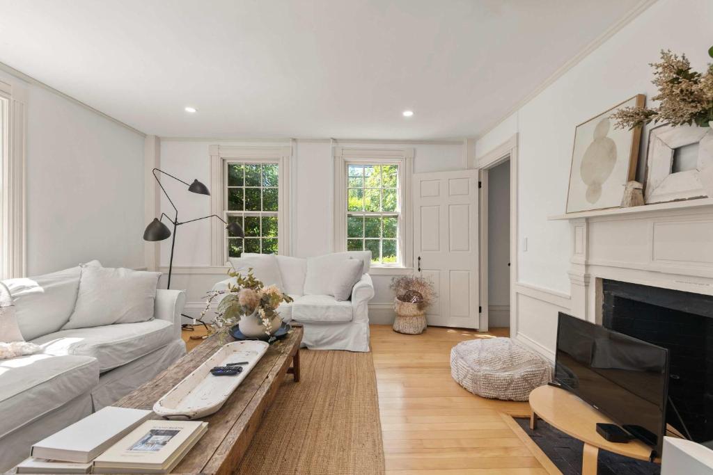 a living room with a couch and a fireplace at Featured in Cape Cod Life Magazine in Barnstable