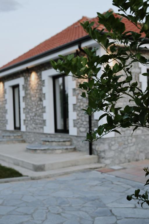 a stone house with a pathway in front of it at Albulena Hotel & Camping in Shkodër