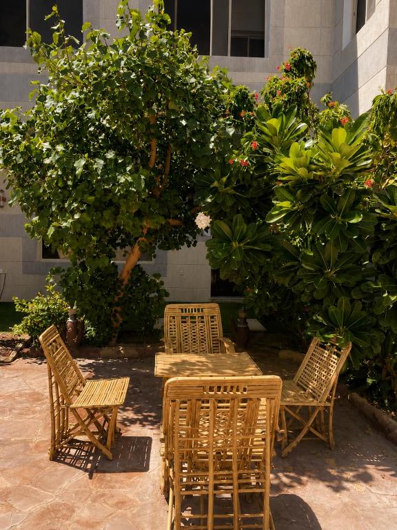 a group of chairs and tables in a garden at فيلا وشاليه الجبل الاحمر in Al-ʿUla