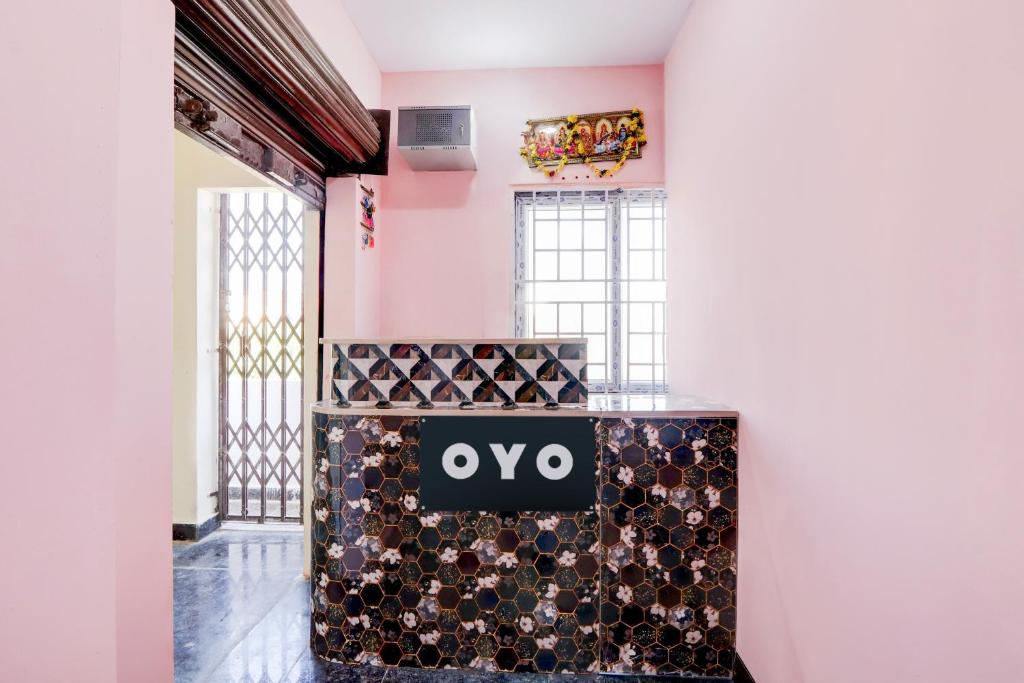 a room with a table filled with wine bottles at Hotel O KSR GRAND in Maula Ali