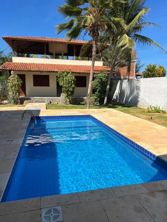 a swimming pool in front of a house at Casa com piscina em Canoa Quebrada in Canoa Quebrada