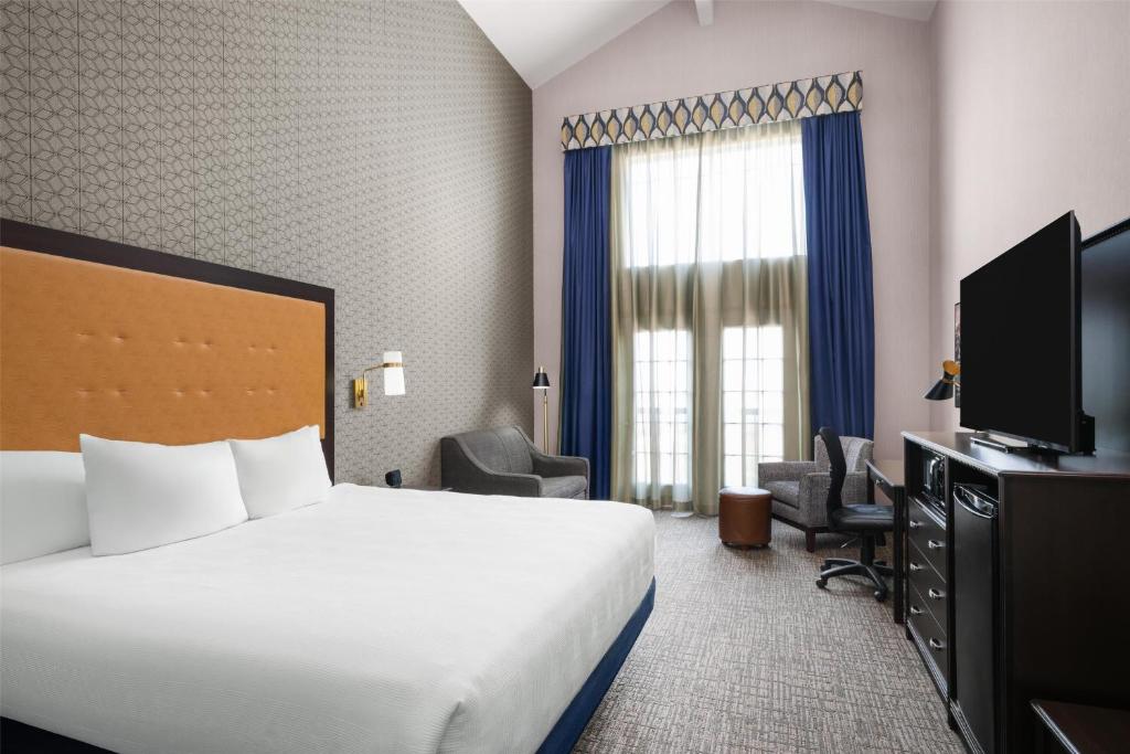 a hotel room with a bed and a television at Best Western Plus Grant Creek Inn in Missoula