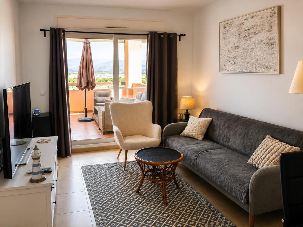 a living room with a couch and a table at Condado de Alhama - Suchan living in El Romero