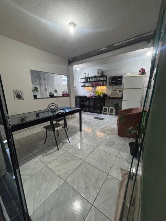 a living room with a table and a fireplace at Beco 6 in Petrópolis