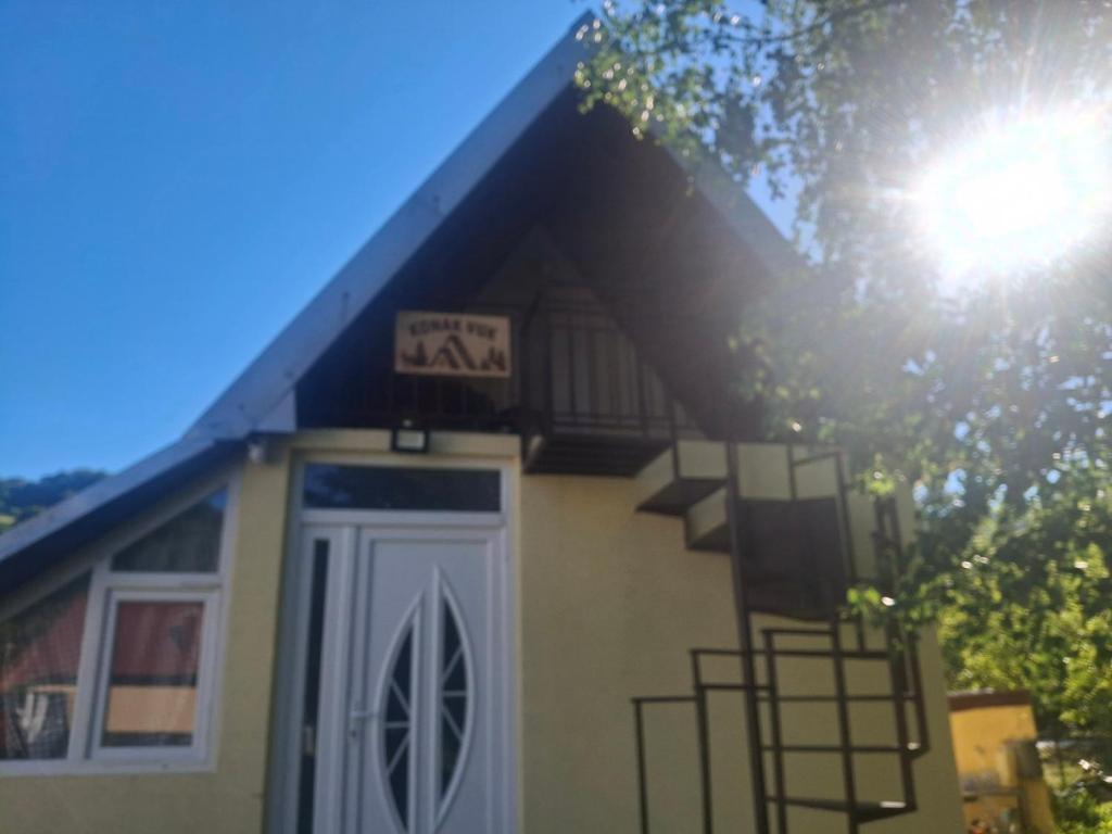 a small house with a sign above the door at Konak Vuk in Veruša
