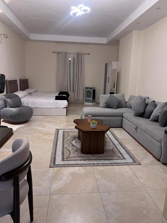 a living room with a couch and a coffee table at New Alamein Latine district Spacious studio direct Lagon view in El Alamein