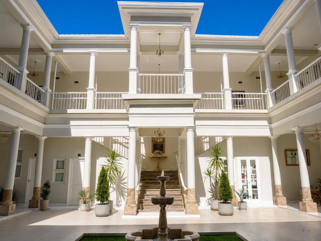 a large building with a fountain in a courtyard at Patrimonial Hotel Boutique in Cochabamba