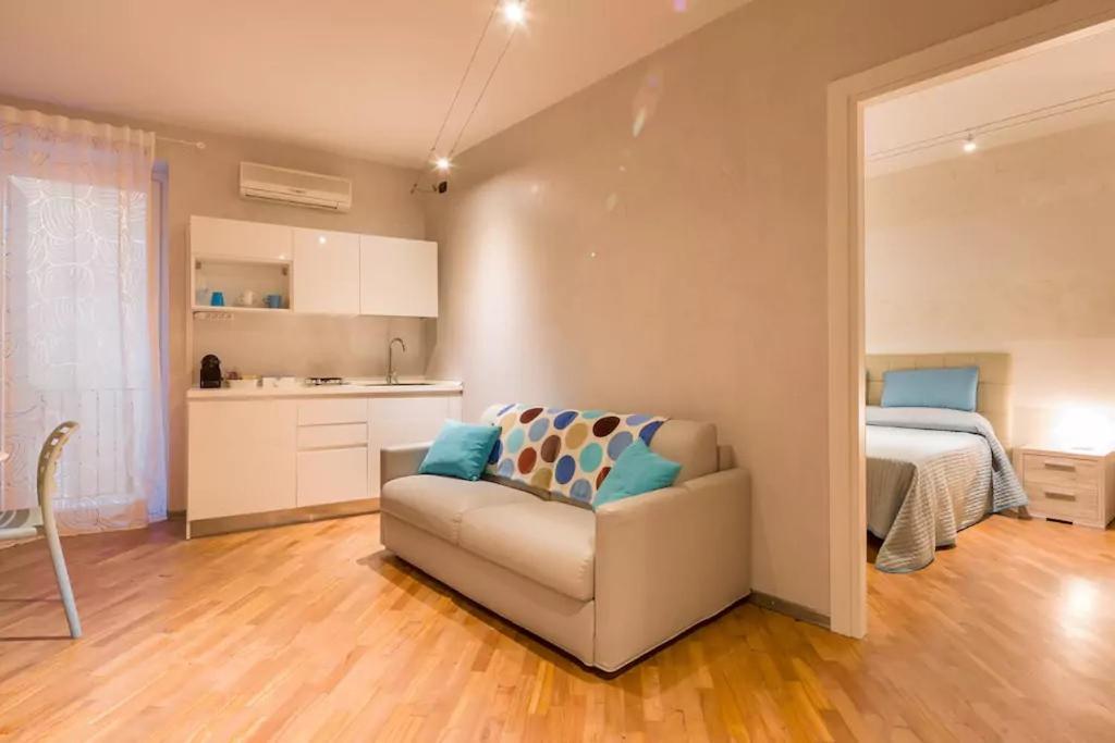 a living room with a couch and a bedroom at Appartamento Oberdan in Verona