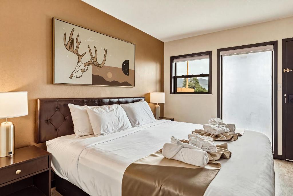 a bedroom with a large bed with a deer on it at LUXX Taos Motor Lodge in Taos