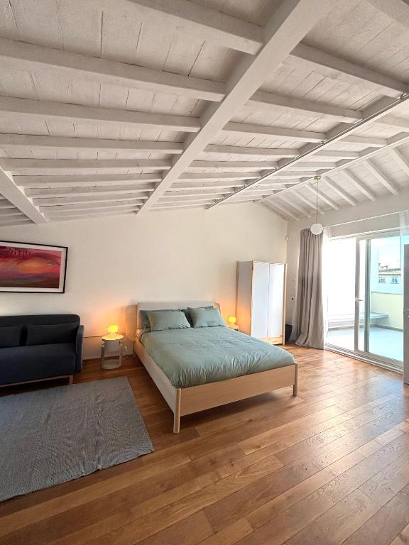 a bedroom with a bed and a couch in it at Casa Lucibell in Prato