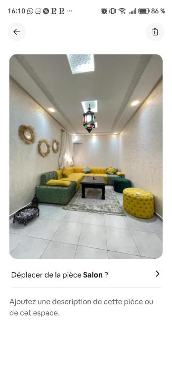 a living room with yellow and green couches and a table at Benjelloun in Marrakesh