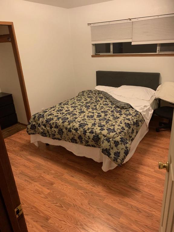 a bedroom with a bed in a room with a wooden floor at 4 Room Sleeps 8plus Tranquil Home in Santa Cruz